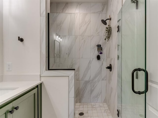 bathroom with a shower with shower door and vanity