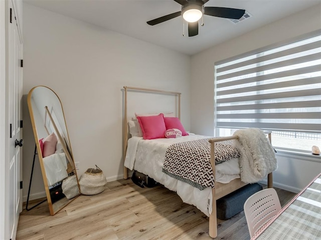 bedroom with ceiling fan and light hardwood / wood-style floors