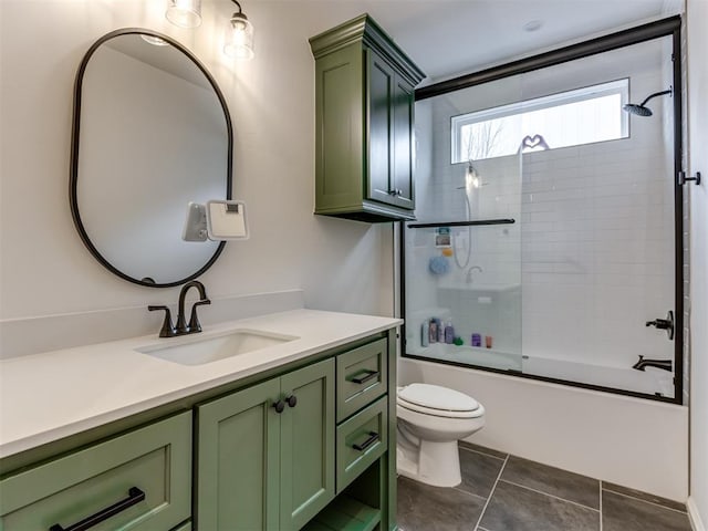 full bathroom featuring toilet, vanity, tile patterned flooring, and shower / bath combination with glass door