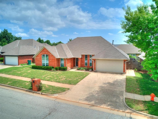 view of front of property with a garage and a front lawn