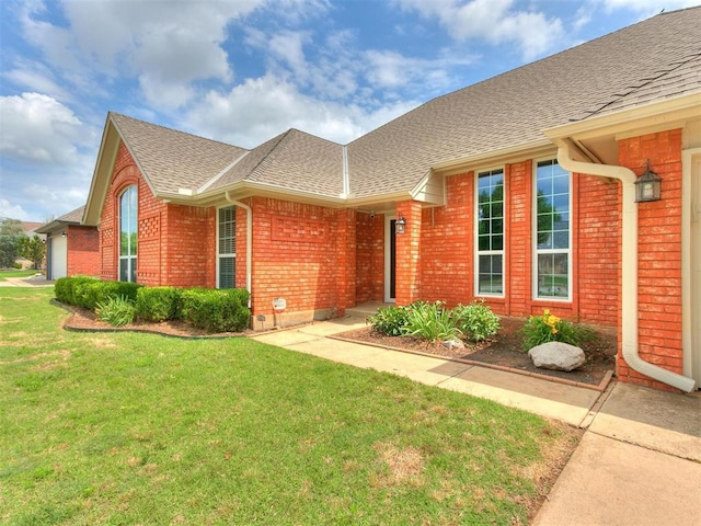 view of front of property with a garage and a front lawn