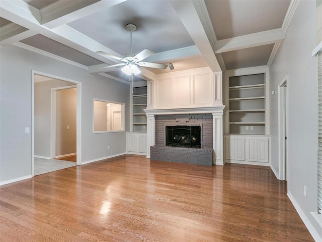 unfurnished living room with coffered ceiling, a fireplace, and light hardwood / wood-style flooring