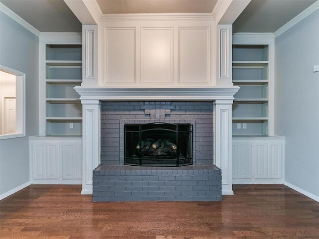 details featuring built in shelves, ornamental molding, wood-type flooring, and a brick fireplace