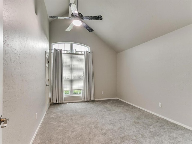 unfurnished room featuring ceiling fan, vaulted ceiling, and light carpet