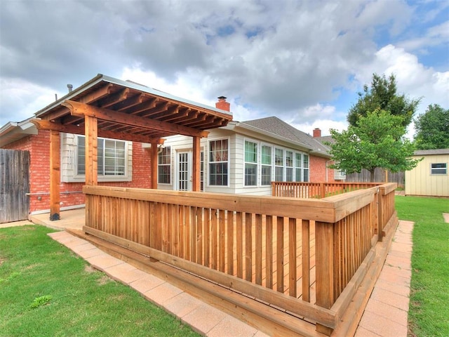 wooden terrace featuring a yard