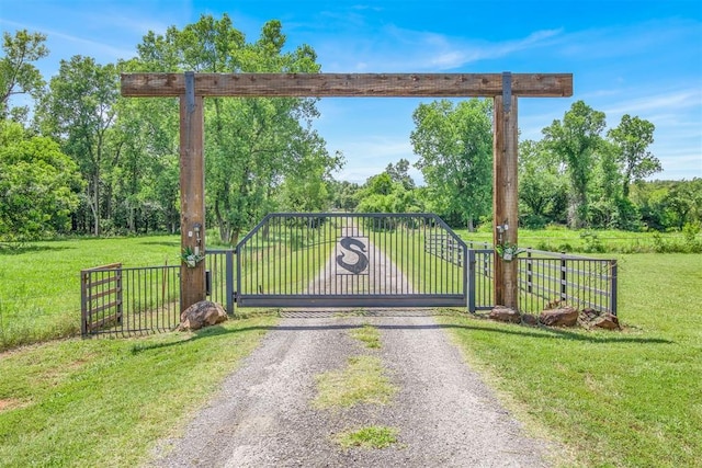 view of gate featuring a yard