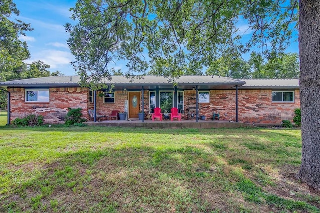 back of house featuring a lawn and a patio