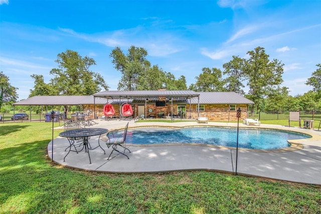 view of pool featuring a lawn