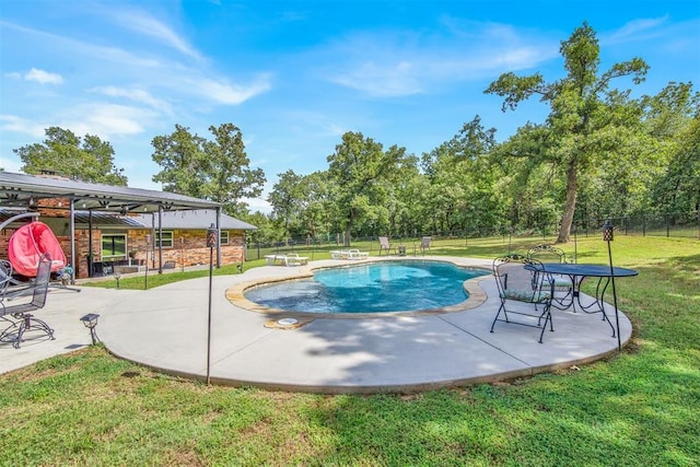 view of pool with a patio area and a yard