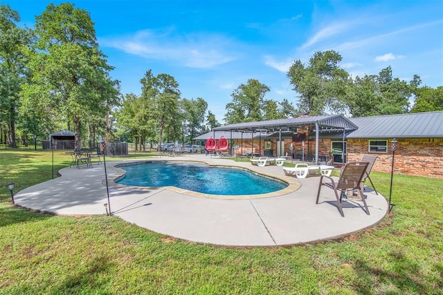 view of pool featuring a lawn and a patio area