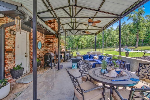 view of patio with ceiling fan, an outdoor hangout area, and grilling area