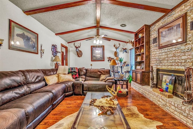 living room featuring wood-type flooring, lofted ceiling with beams, and a textured ceiling