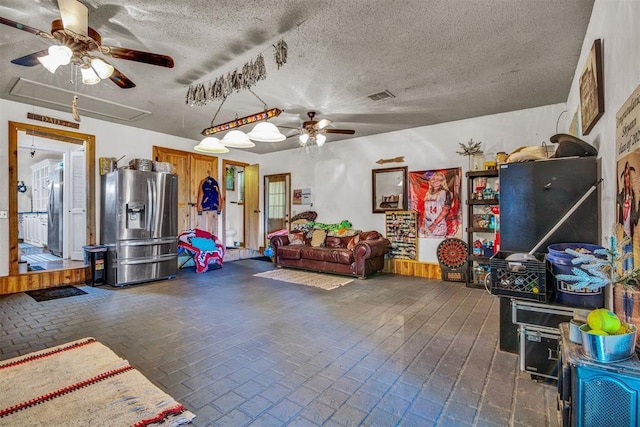 playroom featuring ceiling fan and a textured ceiling