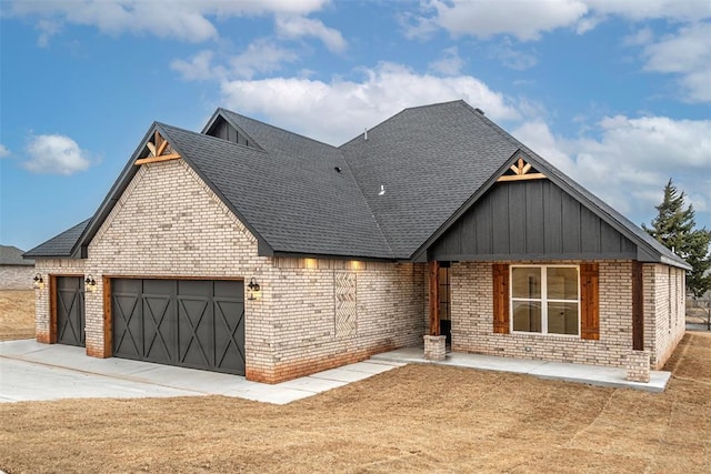 1127 Deer Rdg, Tuttle, OK 73089 - view of front of house with brick siding, board and batten siding, a garage, and a shingled roof