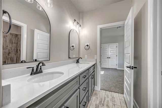 1127 Deer Rdg, Tuttle, OK 73089 - full bathroom featuring double vanity and wood finished floors
