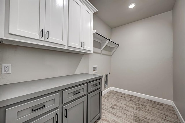 1127 Deer Rdg, Tuttle, OK 73089 - washroom with cabinet space, light wood-type flooring, recessed lighting, and washer hookup