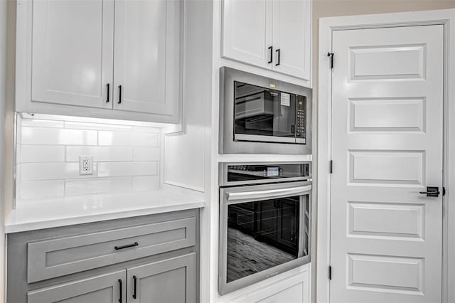 1127 Deer Rdg, Tuttle, OK 73089 - kitchen with oven, built in microwave, and light countertops