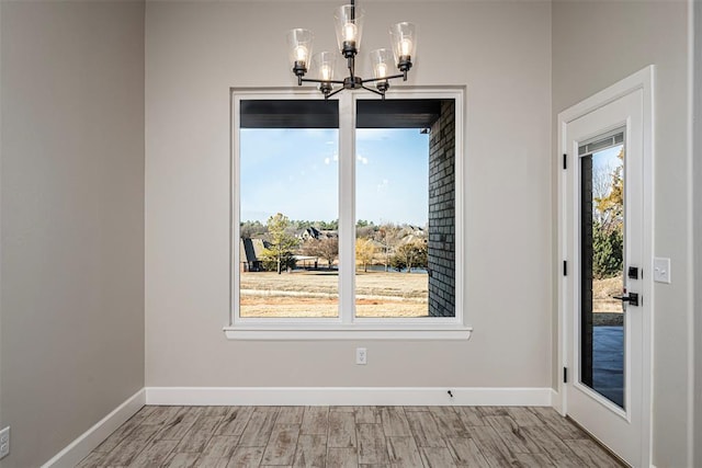 1127 Deer Rdg, Tuttle, OK 73089 - unfurnished dining area featuring a chandelier and light wood-style floors