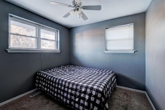 bedroom featuring dark carpet and ceiling fan