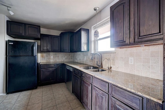 kitchen featuring black appliances, hanging light fixtures, dark brown cabinetry, sink, and light tile patterned flooring