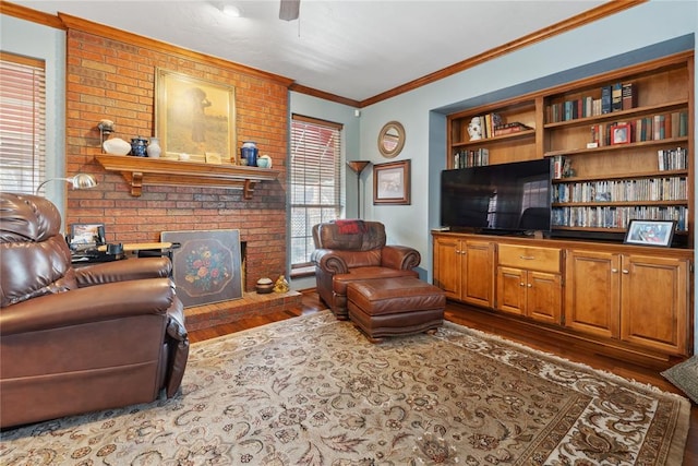 living room featuring hardwood / wood-style floors, a healthy amount of sunlight, crown molding, and a brick fireplace