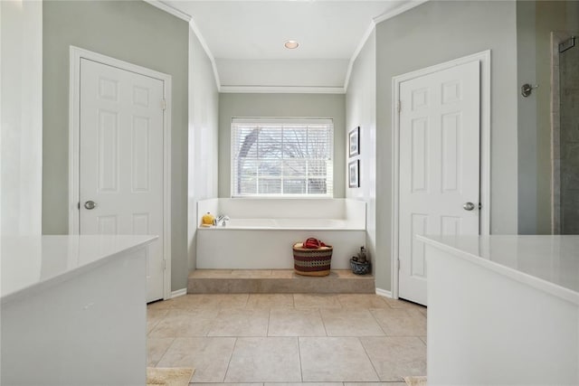 bathroom with a washtub and tile patterned flooring