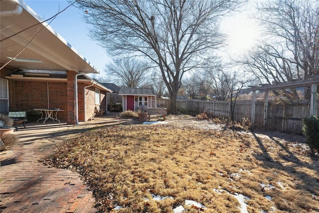 view of yard with an outbuilding and a patio