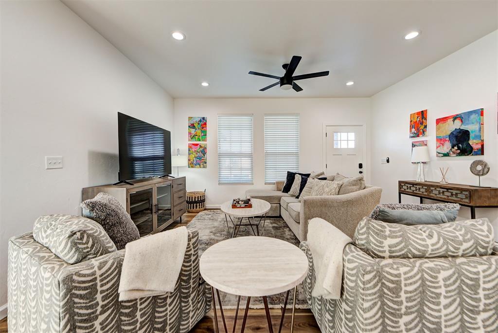 living room featuring ceiling fan and wood-type flooring