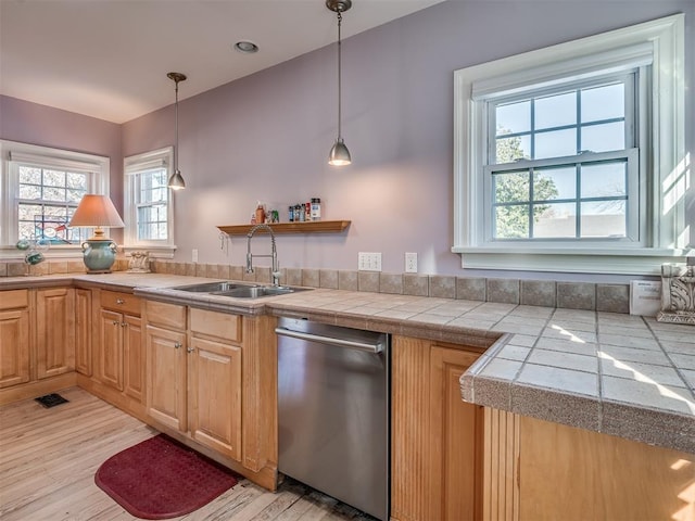 kitchen with dishwasher, light hardwood / wood-style floors, a healthy amount of sunlight, pendant lighting, and sink