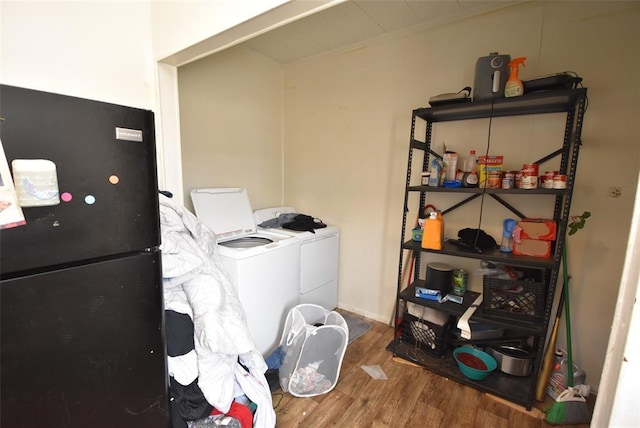 washroom featuring hardwood / wood-style flooring and separate washer and dryer