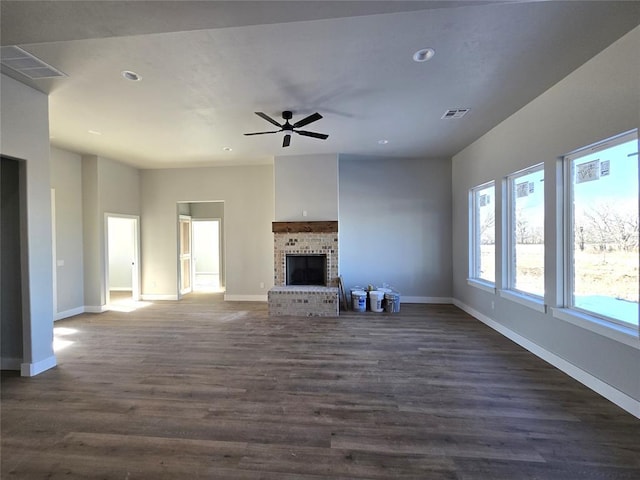 unfurnished living room featuring a fireplace, ceiling fan, and dark hardwood / wood-style floors