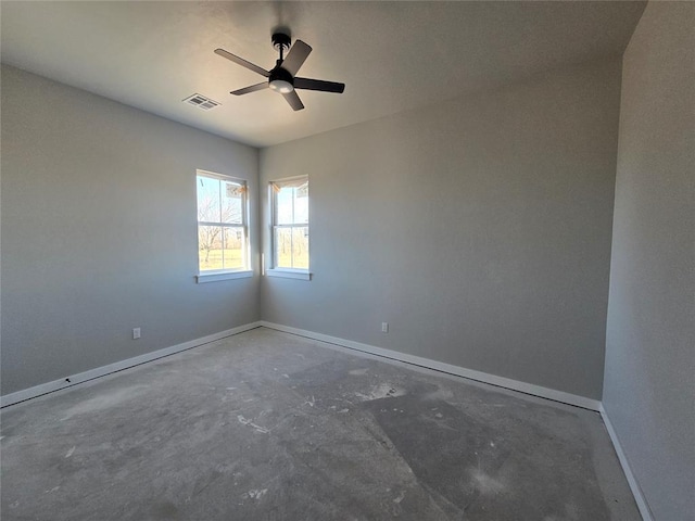 unfurnished room featuring ceiling fan and concrete flooring