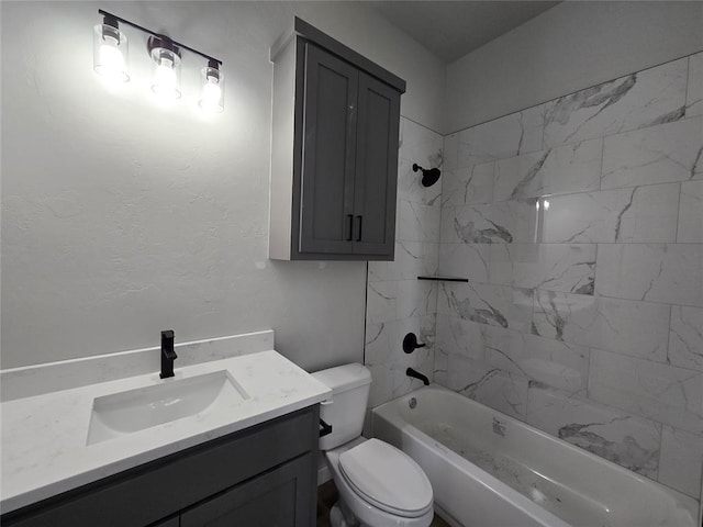 full bathroom featuring toilet, tiled shower / bath, and vanity