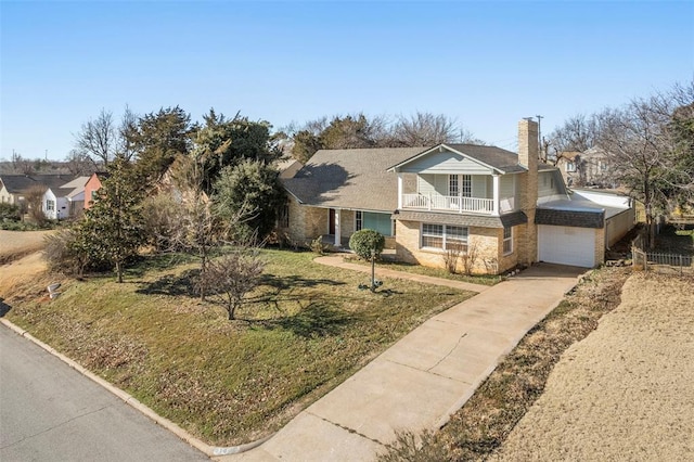 view of front of property featuring a front lawn, a garage, and a balcony