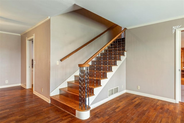 stairs with crown molding and hardwood / wood-style flooring