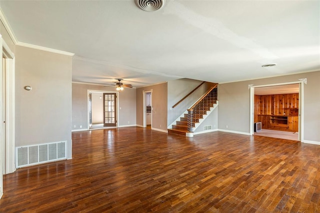 unfurnished living room with ceiling fan, dark wood-type flooring, and ornamental molding