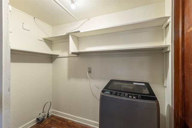 laundry area with dark hardwood / wood-style floors and washer / dryer