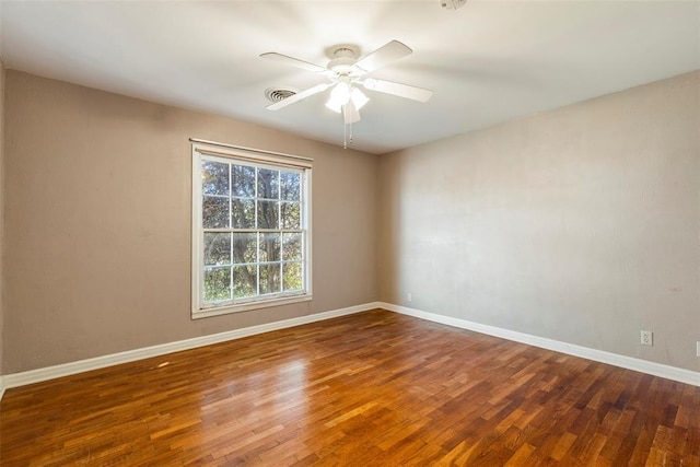 empty room with ceiling fan and dark wood-type flooring