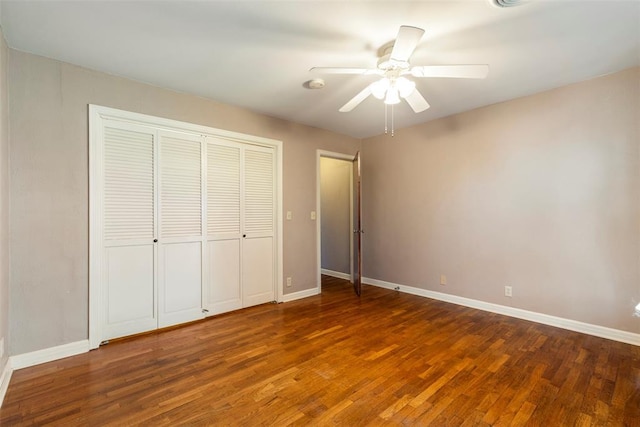 unfurnished bedroom with ceiling fan, a closet, and dark hardwood / wood-style flooring