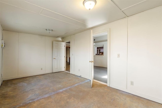 unfurnished bedroom with concrete flooring