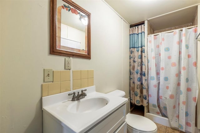 bathroom featuring toilet, vanity, tile patterned flooring, and a shower with shower curtain