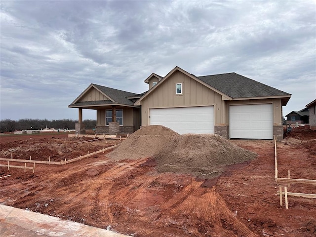 view of front of home featuring a garage, driveway, roof with shingles, board and batten siding, and brick siding