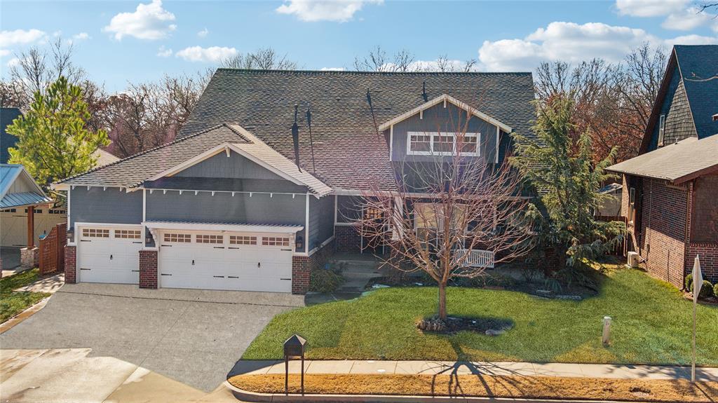 7224 Skipping Stone Dr, Edmond, OK 73034 - view of front of house with concrete driveway, an attached garage, a shingled roof, and a front yard