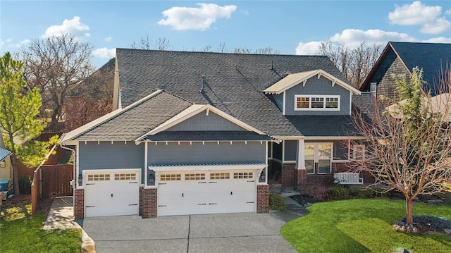 view of front of property featuring brick siding, an attached garage, driveway, and a front lawn