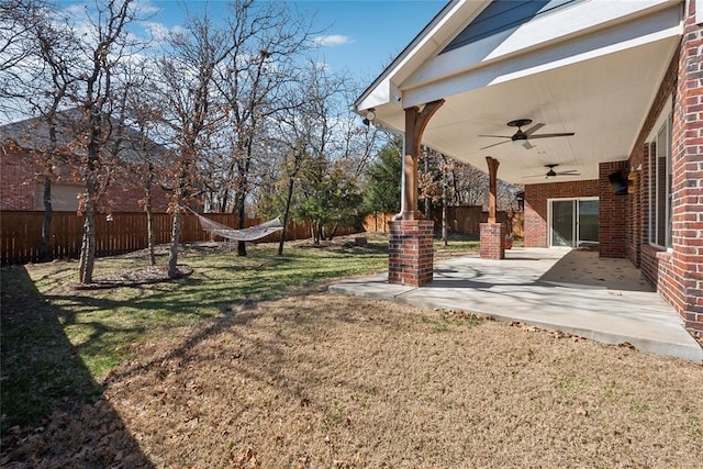 view of yard featuring a patio, a ceiling fan, and fence