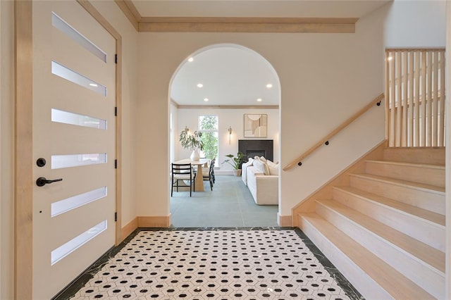 tiled foyer entrance featuring ornamental molding