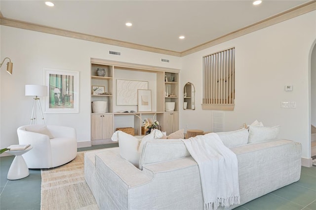 living room with built in features and crown molding