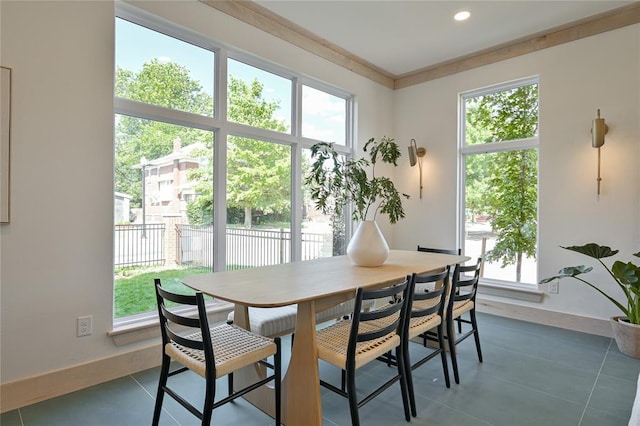 dining space with ornamental molding