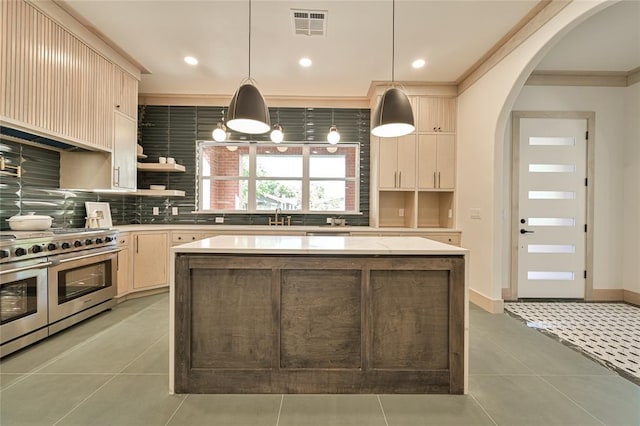 kitchen featuring sink, decorative light fixtures, tile patterned flooring, a kitchen island, and double oven range