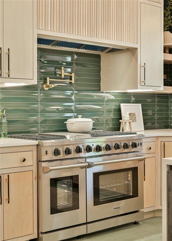 kitchen featuring decorative backsplash and double oven range